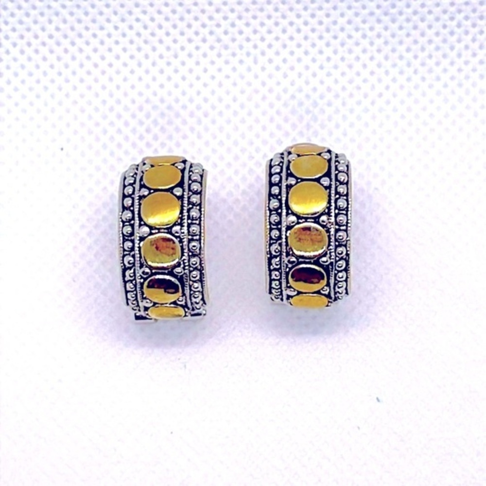 Beautiful gold and silver tone hoops. Gold circular design with one piece clasp.